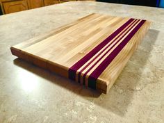 a wooden cutting board sitting on top of a counter