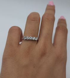 a woman's hand with a diamond ring on it