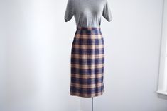 "Description: A navy and brown plaid pencil skirt with back metal zipper and snaps for closure. Unlined. Measurements of garment, allow space for fit. Waist: 25.5\" Hips: 38\" Length: 28\" I take my measurements flat, and double for circumference. Tag: No tag, looks handmade. Fabric: Wool or blend Condition: Excellent Follow along on instagram @lovecharlesvintage" Bonnie Cashin, Plaid Pencil Skirt, Grand Rapids Mi, Navy And Brown, Brown Plaid, Handmade Fabric, Grand Rapids, Metal Zipper, Dresses Xs