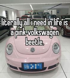 a pink vw bug parked in a garage with the words literally all i need in life is a pink volkswagen beetle beetle