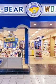 the entrance to a toy store with teddy bears in it's window display area