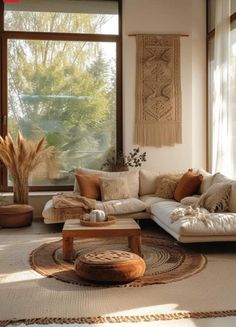 a living room filled with lots of furniture next to a large window covered in plants