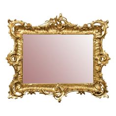 an ornate gold framed mirror against a white background