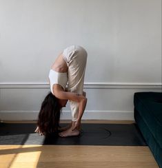 a woman is doing yoga on the floor