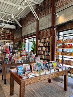 an open book store with lots of books on the shelves and tables full of books