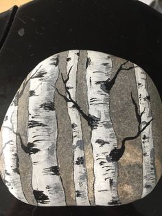 a black and white plate with trees painted on it