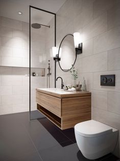 a bathroom with a toilet, sink and mirror in it's center wall area