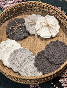 a basket filled with crocheted coasters on top of a rug