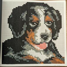 a dog made out of squares on a wooden surface with the image of a dog's face