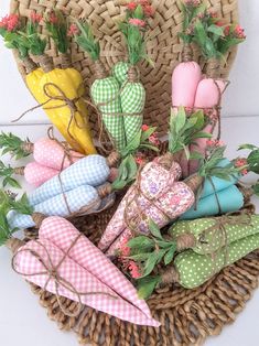 a basket filled with lots of different types of umbrellas and flowers on top of it