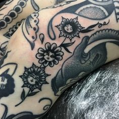 a close up of a person's leg with tattoos on it