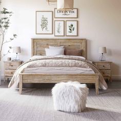 a bedroom with a bed, two nightstands and pictures on the wall above it