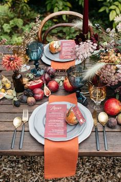 the table is set with plates and silverware