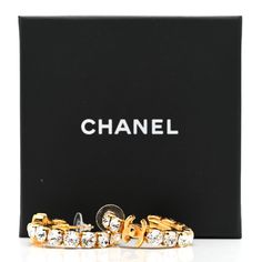 This is an authentic pair of CHANEL Crystal CC Turnlock Hoop Earrings in Gold. These stunning hoop earrings are crafted in a gold tone and feature a mini Chanel CC logo encrusted in crystals. Mini Chanel, Hoop Earrings Gold, Chanel Earrings, Chanel Jewelry, Earrings In Gold, Cc Logo, Earrings Gold, Gold Earrings, Gold Tones