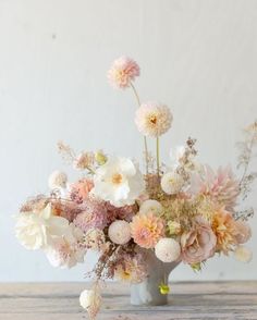 a vase filled with lots of pink and white flowers