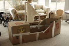 a cardboard boat sitting in the middle of a living room