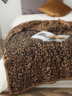 a leopard print blanket on top of a bed