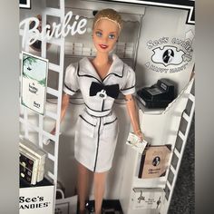 a barbie doll dressed in white and black