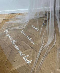 the floor is covered in clear plastic with writing on it and there are shoes underneath