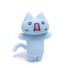 a blue cat figurine with its mouth open and eyes wide open in front of a white background