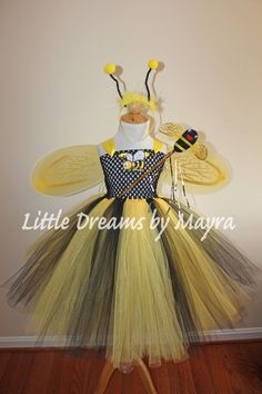 a yellow and black dress with a bee on it