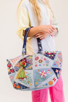 This one goes out to all our boho babes! The Arden is a colorful oversized tote that's sure to brighten up your day. This handmade piece features so many unique details, from the patchwork and tie-dye denim design to the bright fuchsia interior (no more digging in the endless abyss to find your keys). The Arden pairs well with all of your favorite summer activities: farmer's markets, getaways, beach time, and more! Details: 20” long x 14" height x 11” wide 3 interior pockets Patchwork denim deta Bohemian Bags For Everyday Use In Spring, Bohemian Spring Tote Bag, Bohemian Blue Bags For Spring, Bohemian Bags For Everyday Spring, Bohemian Everyday Bags For Spring, Spring Festival Embroidered Bags, Bohemian Blue Canvas Bag, Festival Patchwork Tote Bag, Bohemian Multicolor Cotton Bags