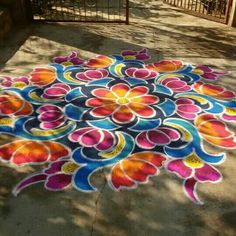 a colorfully painted flower design on the ground