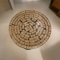 there is a decorative plate made out of wine corks on the floor in this room