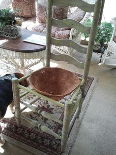 a dog standing next to a chair with a bowl on it's back legs