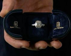 a person holding an engagement ring in a velvet box with the words harry potter written on it