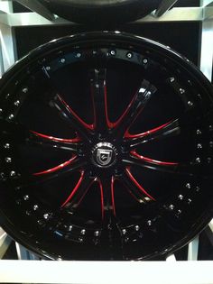 a black wheel with red spokes on display