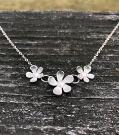 Beautiful, elegant, and whimsical. This silver flower necklace is sure to be a hit! Three darling flowers dance on a delicate yet strong fine silver chain in a length of your choice and secured with a silver lobster clasp. The flowers measure 2 inches across and 7/8 inch tall in the middle. Delicate Silver Jewelry With Flower Decoration, Silver Flower Necklace For Anniversary, Sterling Silver Jewelry With 3d Flower Design, Elegant Sterling Silver Flower Necklace, Silver Flower Necklace For Wedding, Sterling Silver Jewelry With 3d Flowers In Silver, Delicate Silver Flower Jewelry, Elegant Silver Flower Necklace With Decoration, Elegant Sterling Silver Jewelry With 3d Flowers