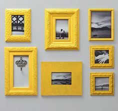 several yellow frames are arranged on the wall, with one person's hand in the middle