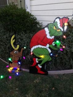 an outdoor christmas decoration with lights and a grino