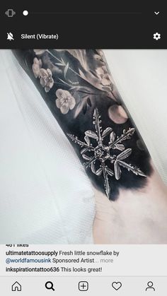 a person with a tattoo on their arm that has flowers and snowflakes on it