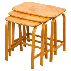 three wooden stools sitting next to each other on top of a white background,