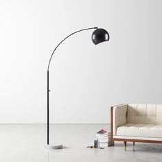 a black floor lamp next to a white couch