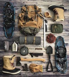 an assortment of hiking gear laid out on a wooden floor