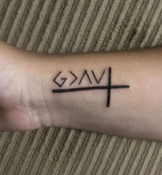 a person with a cross tattoo on their arm