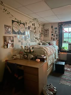 a bed room with a neatly made bed and lots of pictures on the wall