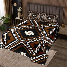 a bed covered in a brown and black blanket