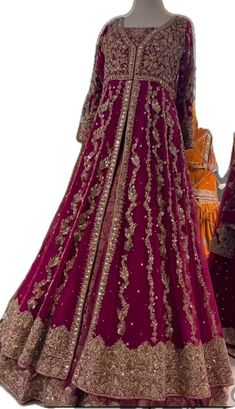 a mannequin dressed in a maroon and gold gown