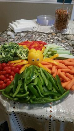 a platter filled with lots of vegetables on top of a table