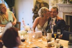 a bride and groom kissing at their wedding reception