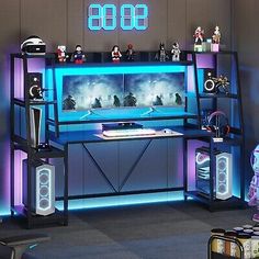 a gaming room with various items on the desk and in front of it is a clock