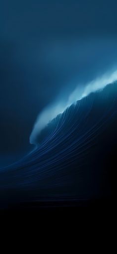 a large wave in the ocean on a cloudy day