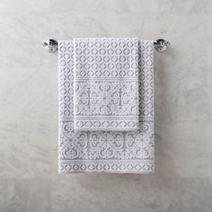 two white towels hanging on the wall