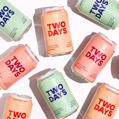 six cans of two days soda on a white surface with the words two days printed on them