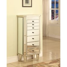 a white chest of drawers sitting in a room next to a mirror and rug on the floor