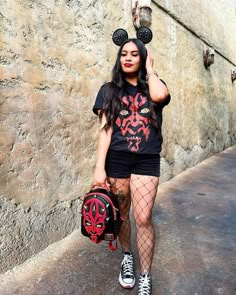 a woman with mickey mouse ears holding a baseball mitt